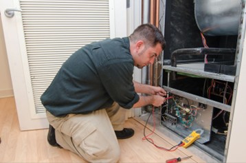 A Shamy technician diagnosing an air handler issue in Perrysburg. Trust your comfort to us!