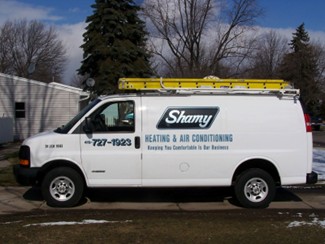 A Shamy Heating & Air Conditioning HVAC service truck parked outside a Rossford residence. Shamy will make sure your Rossford home has clean air. Call today!